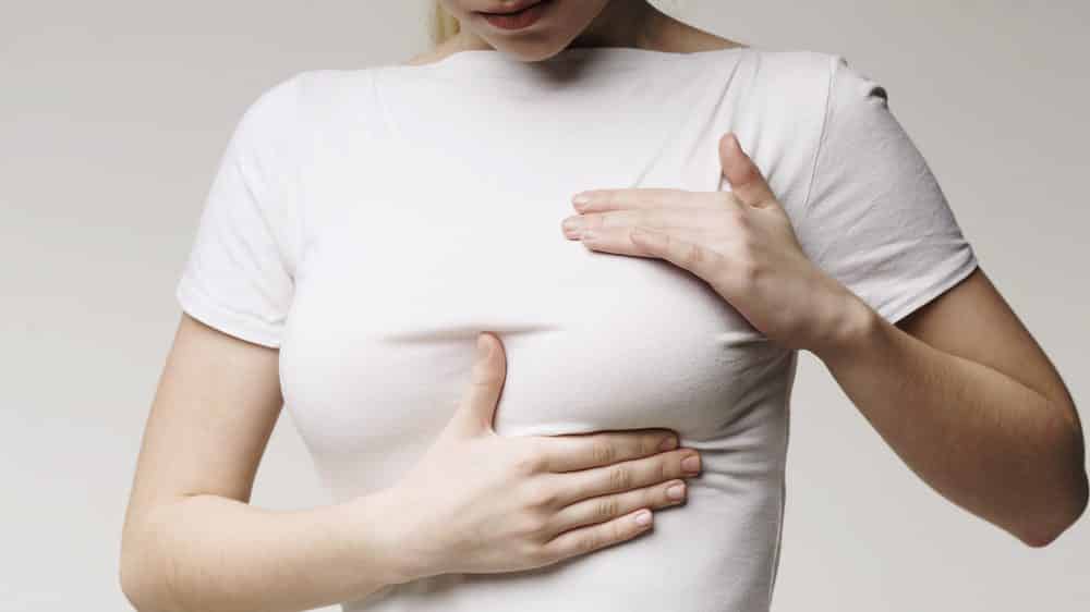 mulher toca os seios. terapia de reposição hormonal do câncer de mama é opção de tratamento