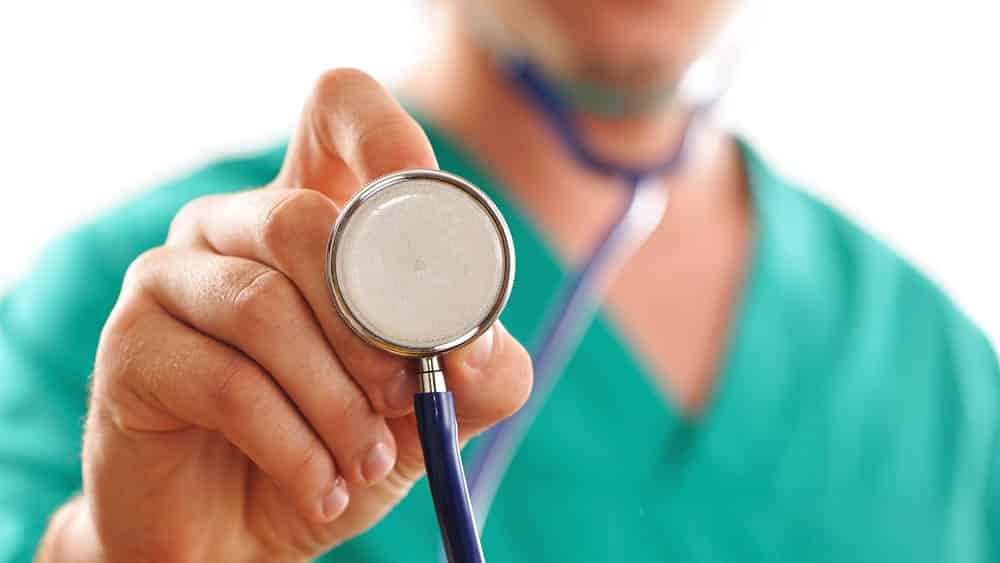 Médico segurando estetoscópio.