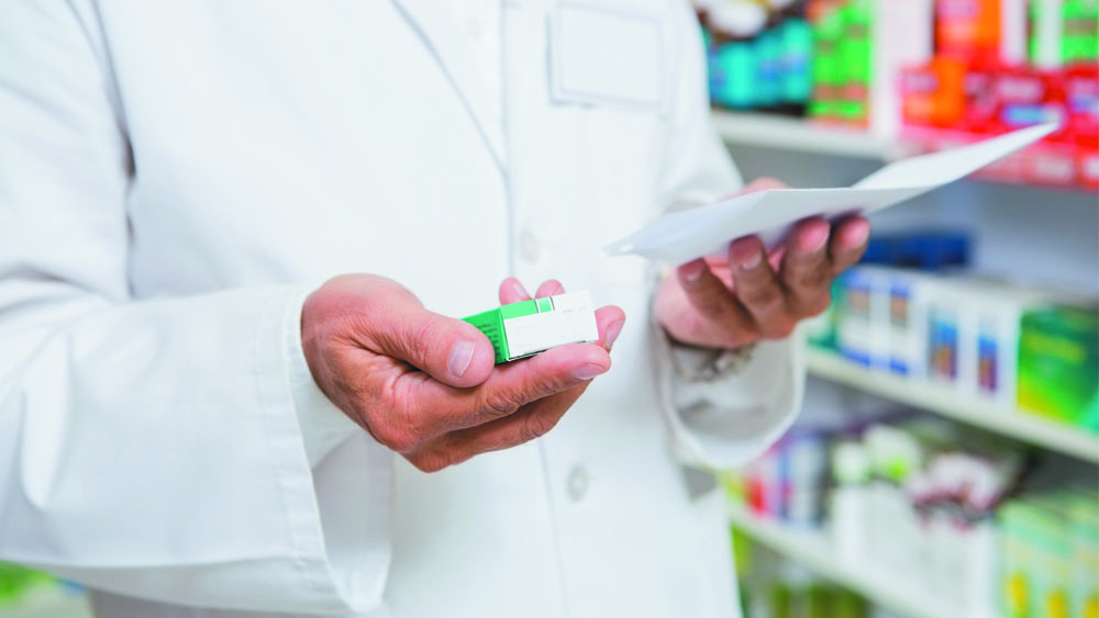 Farmacêutico segura antitérmico, um dos medicamentos que fazem parte do tratamento para controlar os sintomas do coronavírus.